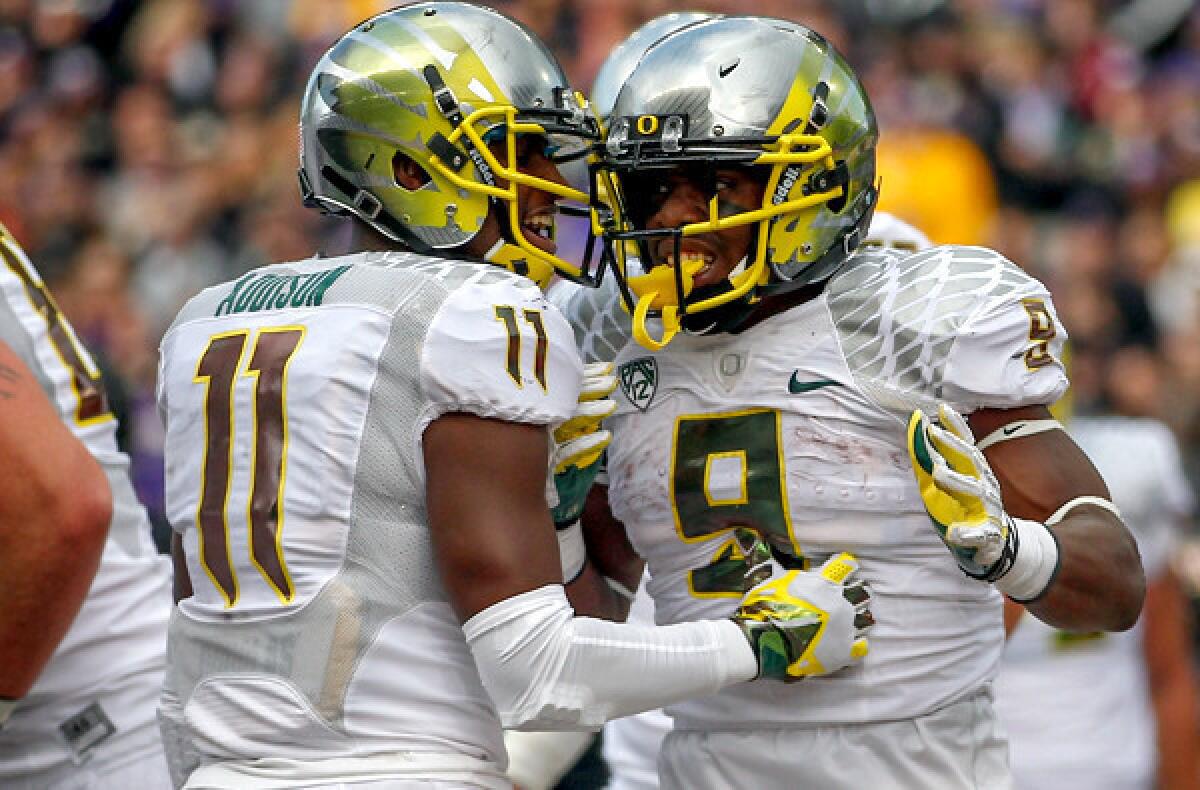 Oregon running back Byron Marshall (9) celebrates with wide receiver Bralon Addison after scoring a touchdown against Washington last week.