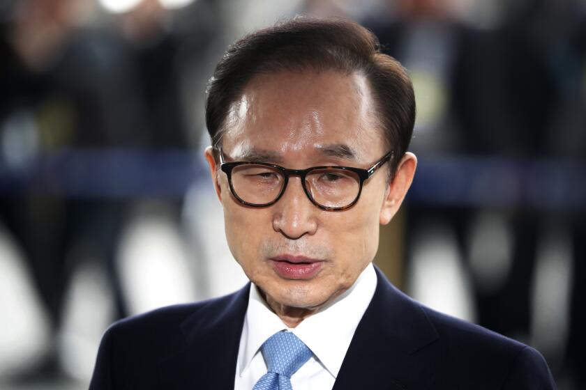 FILE - In this March 14, 2018, file photo, former South Korean President Lee Myung-bak arrives for questioning over bribery allegations at the Seoul Central District Prosecutors' Office in Seoul, South Korea. South Korea’s top court on Thursday, Oct. 29, 2020, upheld a 17-year prison term imposed on ex-President Lee over a range of high-profile corruption charges, a ruling that will send him back to jail again.(Kim Hong-Ji/Pool Photo via AP, File)