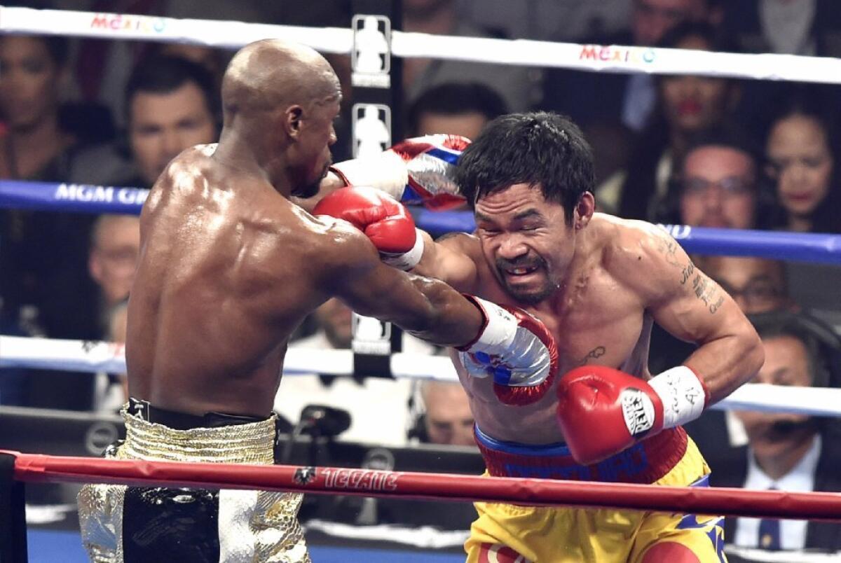 Floyd Mayweather and Manny Pacquiao trade blows during Saturday's fight in Las Vegas.