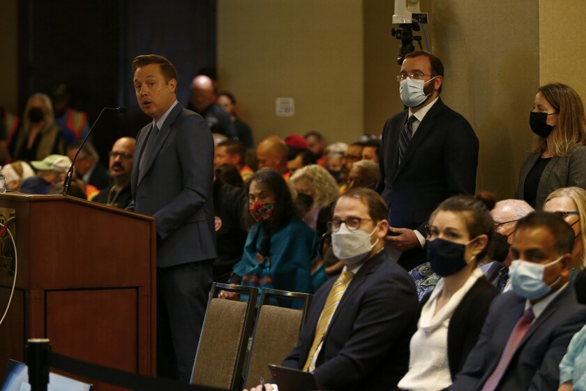 Representatives for Poseidon speak during a California Coastal Commission hearing at the Hilton on Thursday.