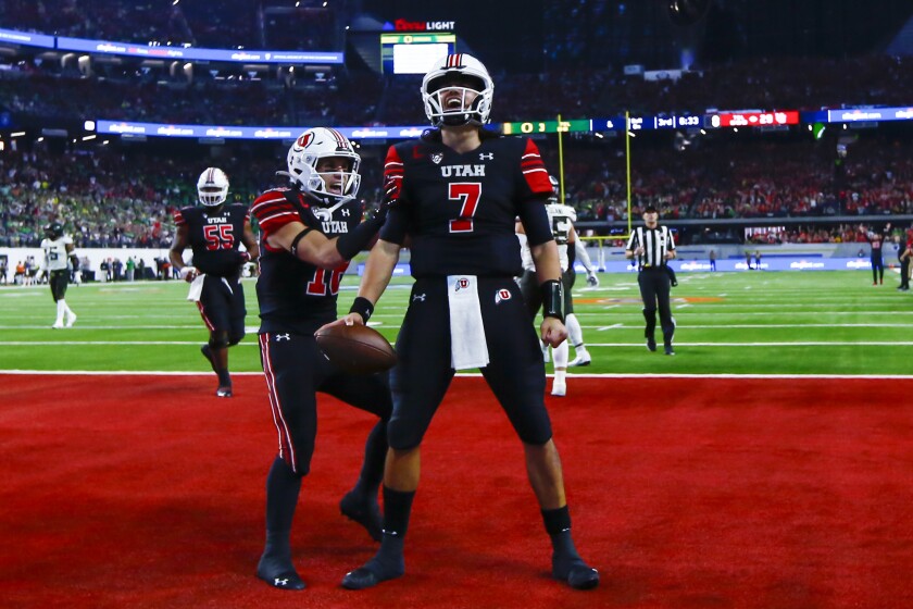 Utah quarterback Cameron Rising (7) celebrates next to wide receiver Britain Covey after scoring on a 2-point conversion against Oregon during the second half of the Pac-12 Conference championship NCAA college football game Friday, Dec. 3, 2021, in Las Vegas. (AP Photo/Chase Stevens)