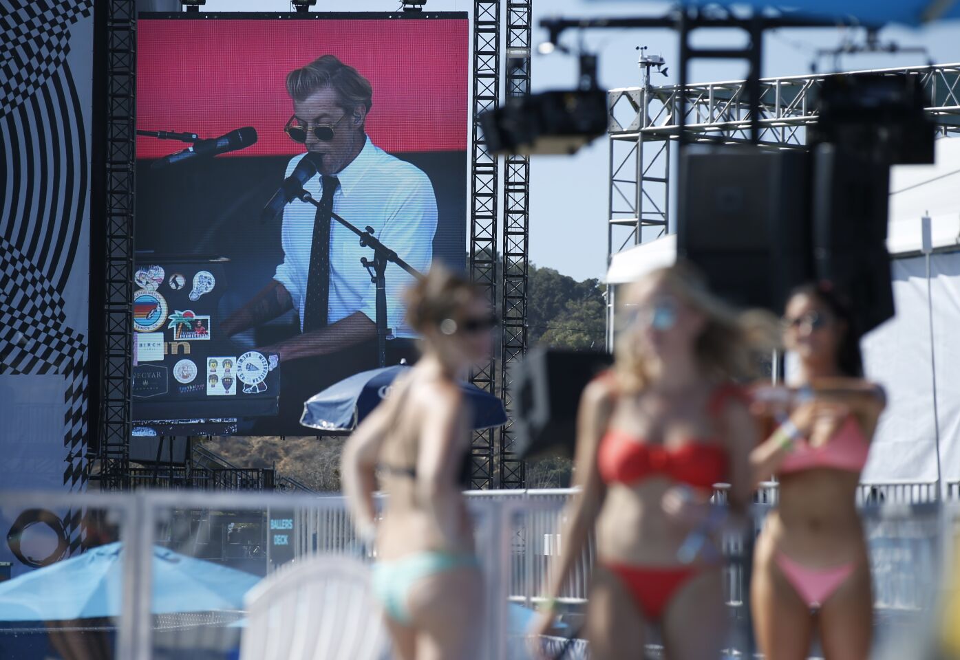 Andrew McMahon, shown on a screen, plays at the Sunset Cliff Stage as people get ready to go in a swimming pool at the Bask Swim Club at KAABOO Del Mar on Sept. 13, 2019.