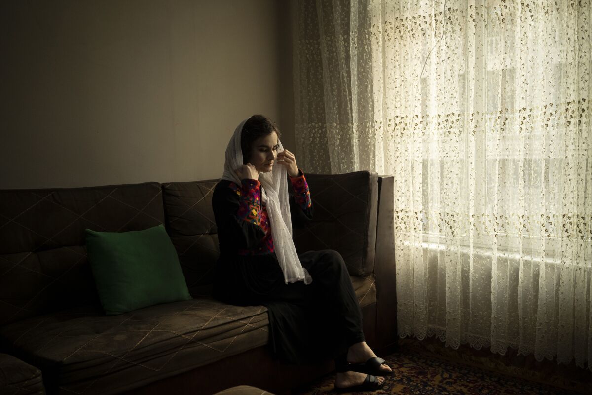 Woman sitting inside her home