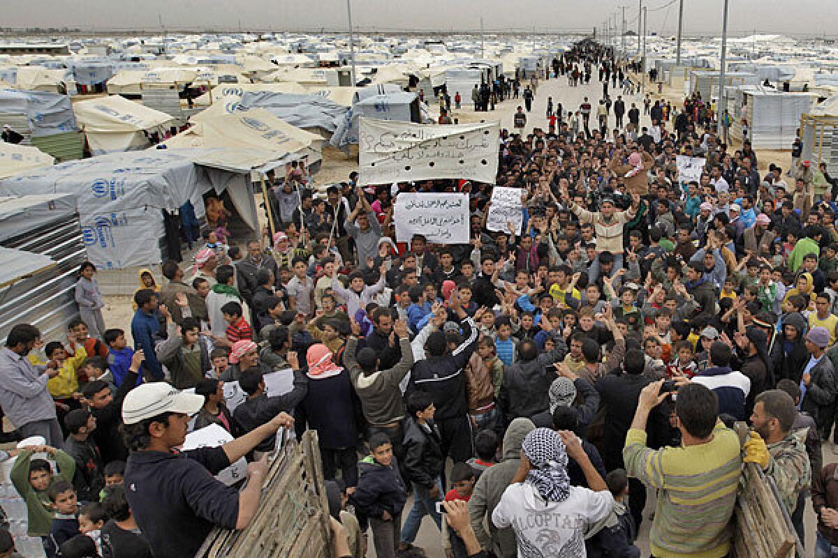 Syrian refugees take part in a demonstration this year at the Zaatari camp in Jordan, near the border with Syria.