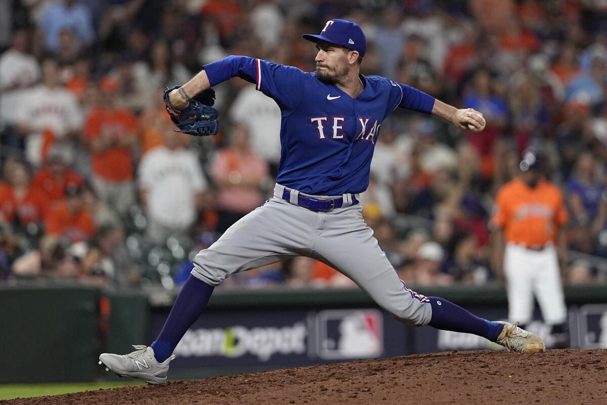 Texas Rangers pitcher Andrew Heaney throws.