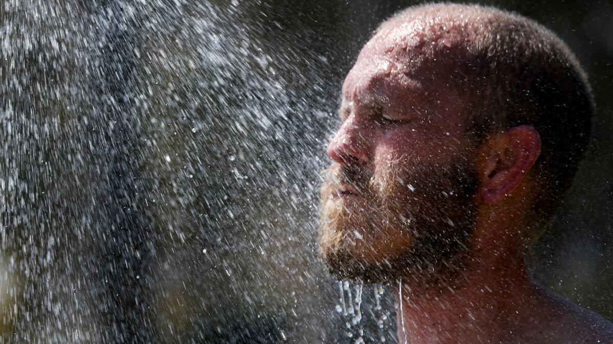 Surfer Joshua Lerch rinses-off after a day of surfing at Doheny State Beach.