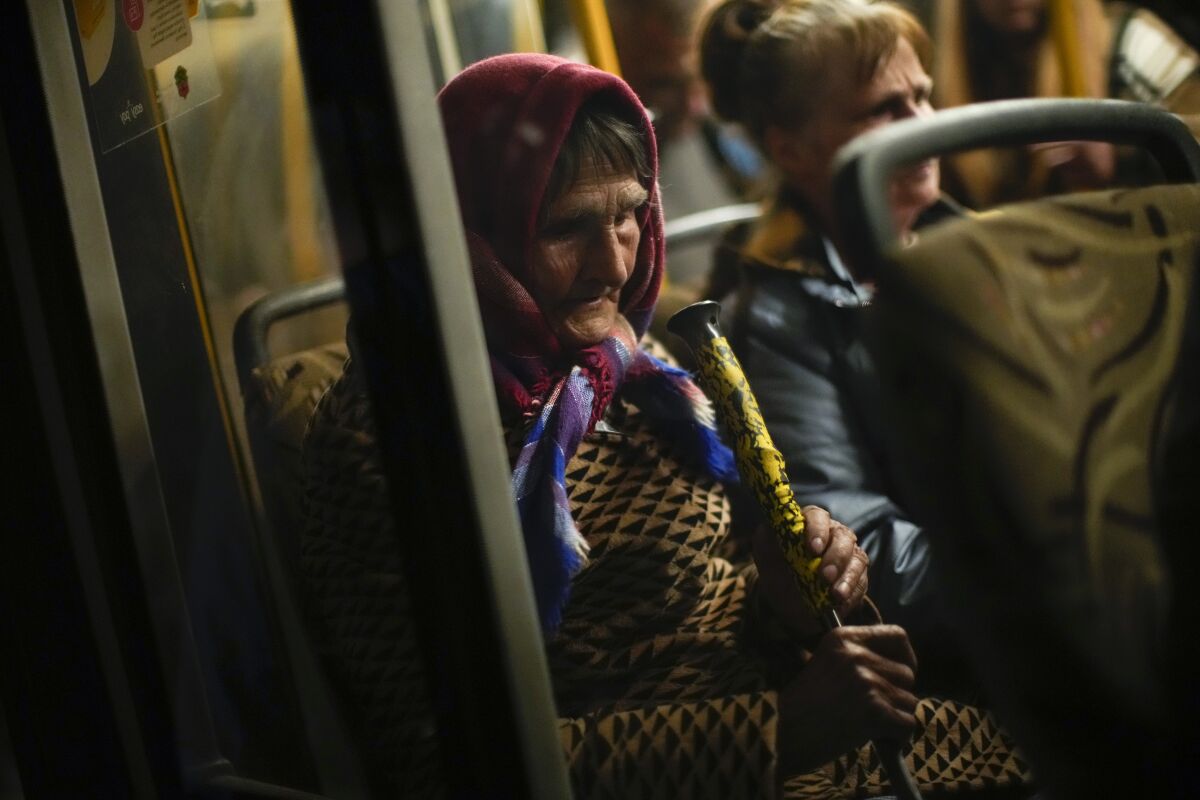 A woman who fled from Mariupol arrives by bus to a reception center for displaced people in Zaporizhzhia, Ukraine, Sunday, May 8, 2022. Thousands of Ukrainian continue to leave Russian occupied areas. (AP Photo/Francisco Seco)