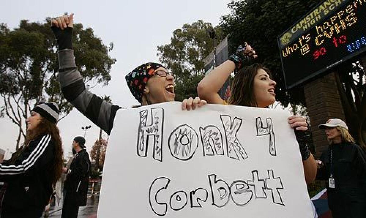 Capistrano Valley High 2005 alumni Gianna DeCaro, 20, far left, joins current students Lauren Stoll, 17, center, and Jamie Barriga, 17, during a rally in support of history teacher James Corbett.