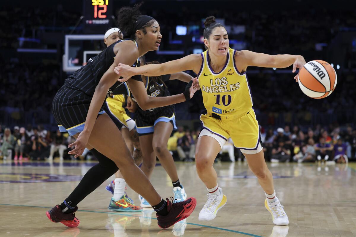 Sparks guard Kelsey Plum draws a foul while driving in front of Chicago Sky forward Angel Reese Sunday.