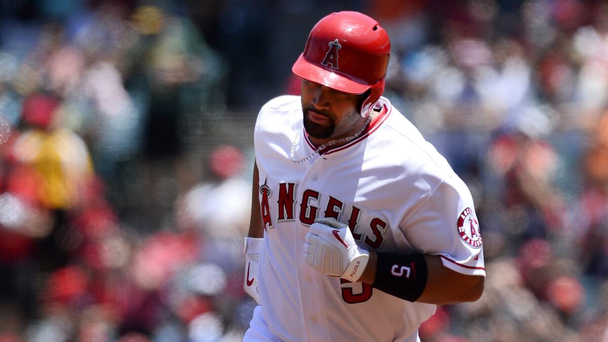 Angels designated hitter Albert Pujols rounds second base after hitting a solo home run in the first inning of a 6-2 win over the Tampa Bay Rays on Sunday.
