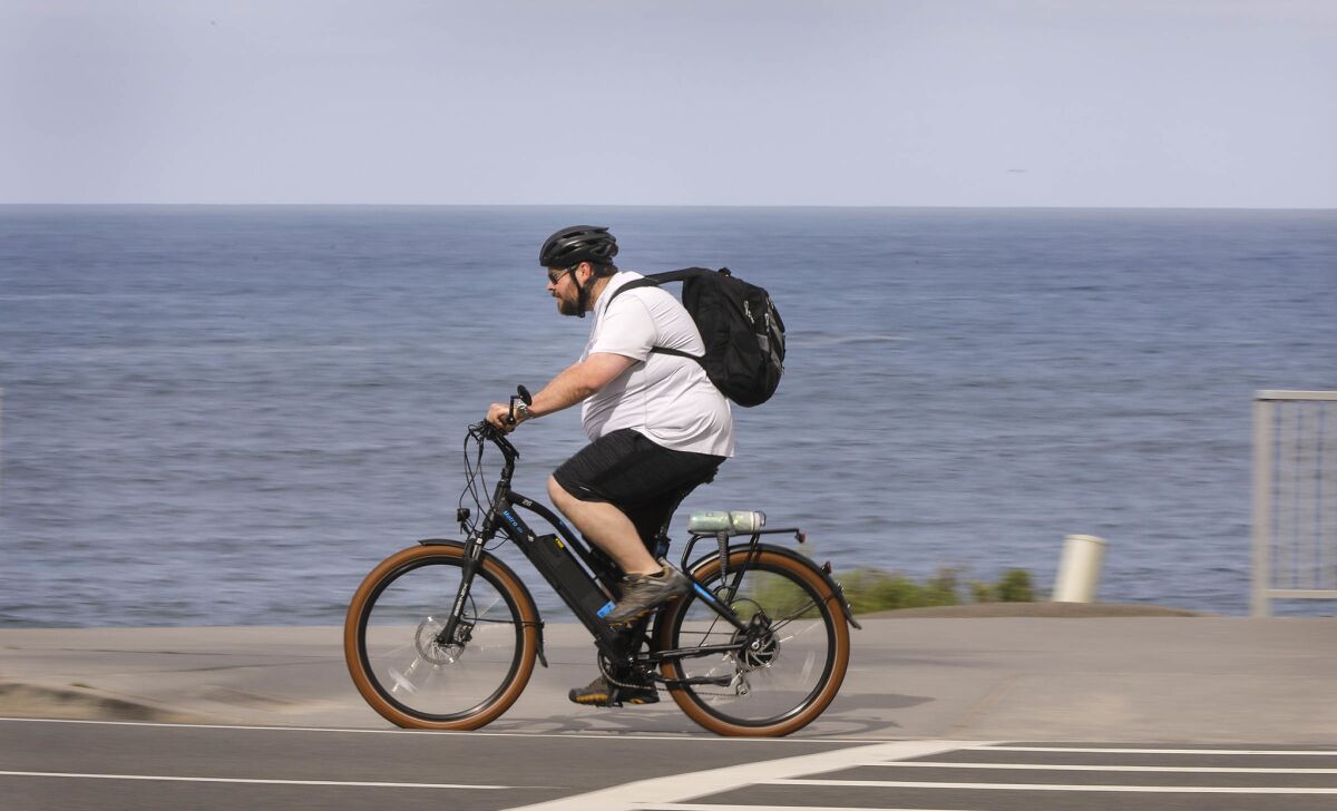 A bicyclist rides along Carlsbad Boulevard at Pine Avenue in Carlsbad during Bike to Work Day 2018.