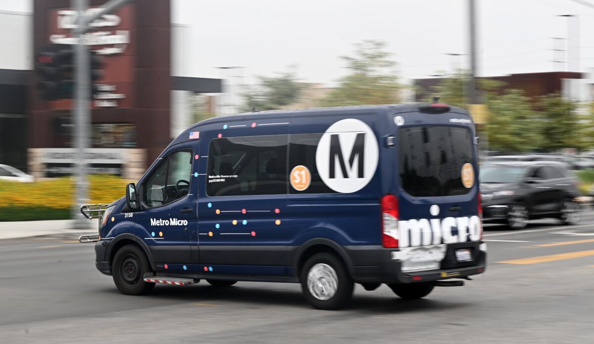 A blue van with a large M logo.