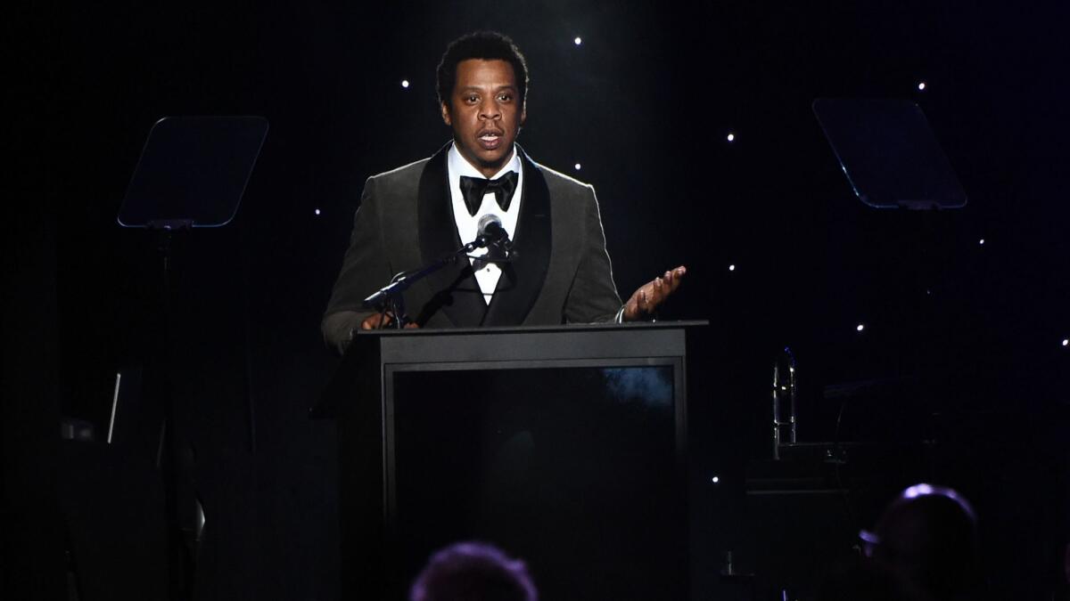Jay-Z accepts an award during Clive Davis' annual pre-Grammy gala on Saturday night in New York.