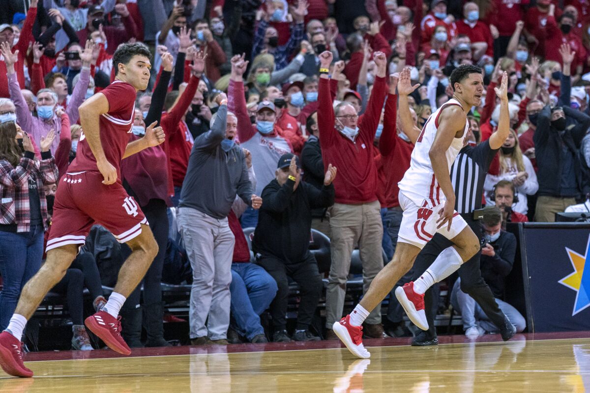 Wisconsin's Johnny Davis, right, reacts after hitting a 3-point, go-ahead basket against Indiana's Anthony Leal, left, during the second half of an NCAA college basketball game Wednesday, Dec. 8, 2021, in Madison, Wis. Wisconsin won 64-59. (AP Photo/Andy Manis)