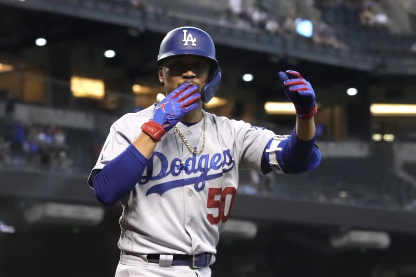Los Angeles Dodgers Mookie Betts reacts after hitting a solo home run against the Arizona Diamondbacks in the ninth inning during a baseball game, Sunday, Aug 1, 2021, in Phoenix. (AP Photo/Rick Scuteri)