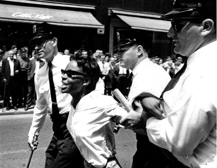 Bertha Gilbert, 22, is led away by police after she tried to enter a segregated lunch counter in Nashville, Tenn. in 1964.
