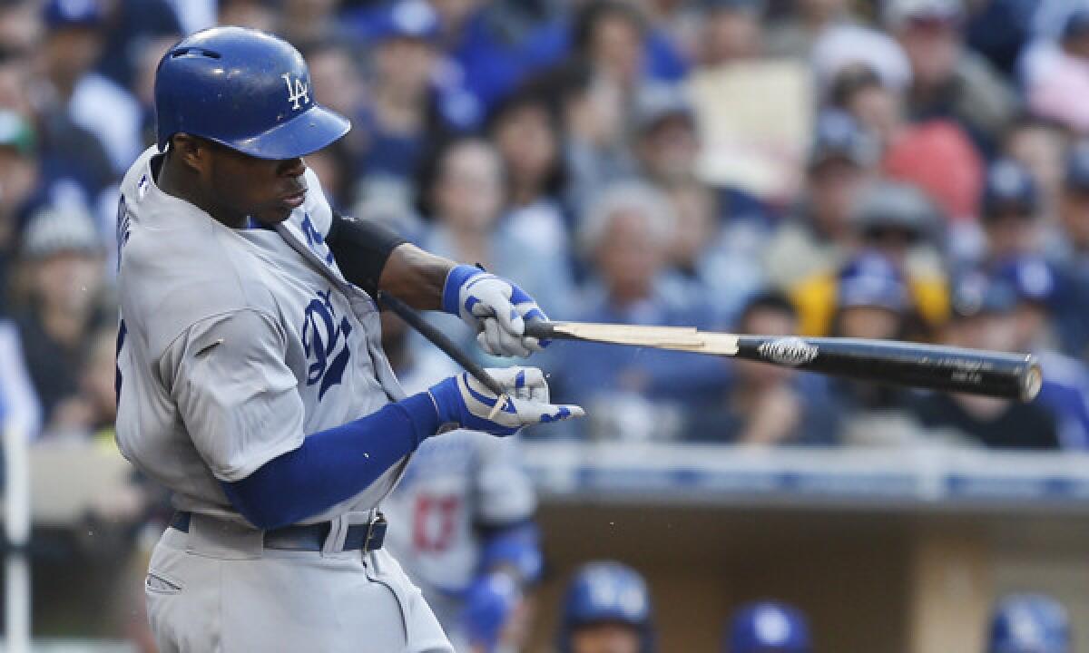 Dodgers right fielder Yasiel Puig breaks his bat while grounding out against the San Diego Padres on March 30. Puig has a ligament strain in his left thumb, but the injury likely will not warrant a trip to the disabled list.