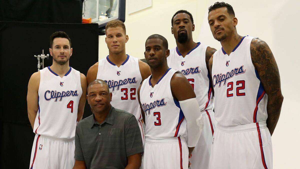 Clippers Coach Doc Rivers, front, poses for photos with Clippers starters (from left to right) J.J. Redick, Blake Griffin, Chris Paul, DeAndre Jordan and Matt Barnes during the team's media day on Sept. 29.