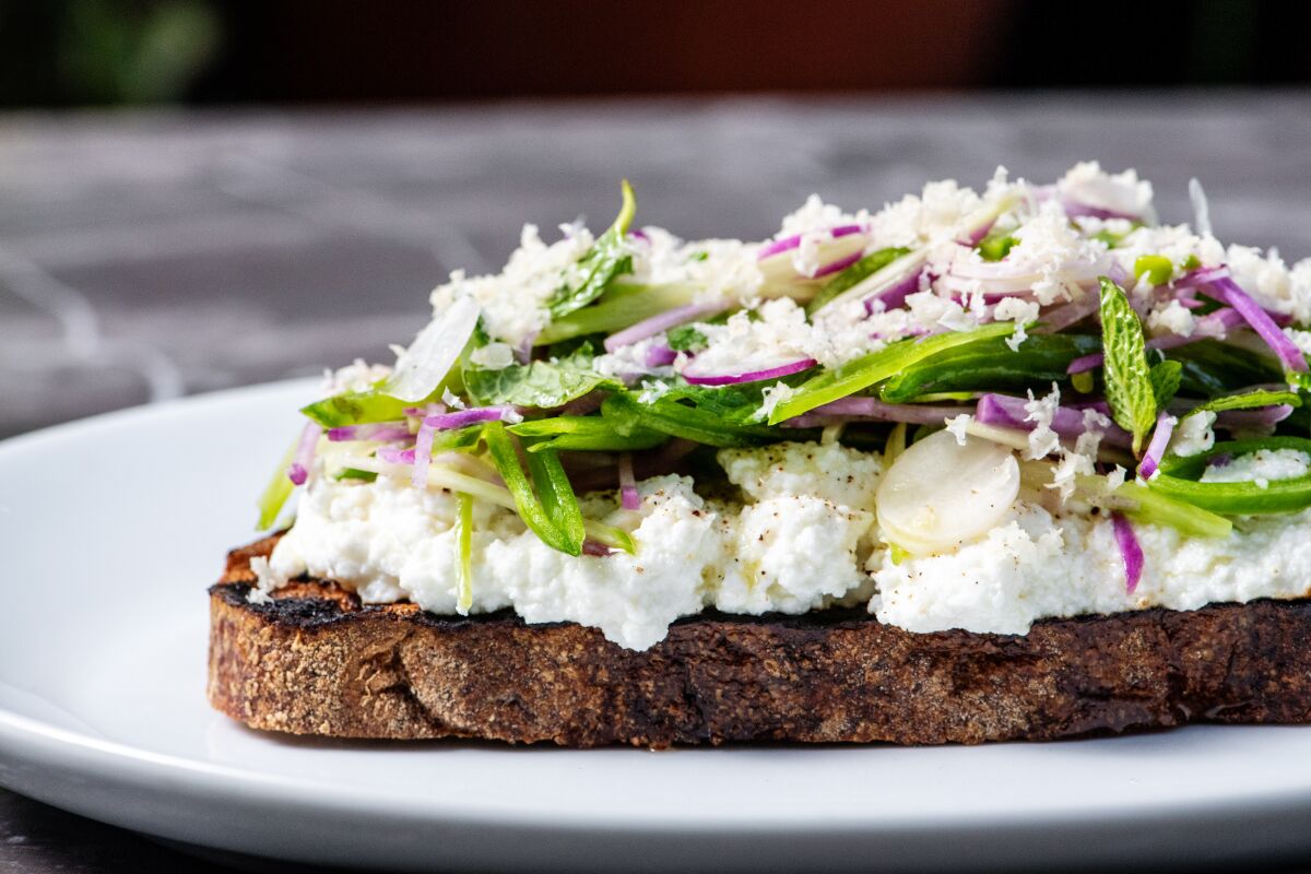 Toast from Clark Street Bread with ricotta, mint, crunch snap pea and spicy radish at Lolo.