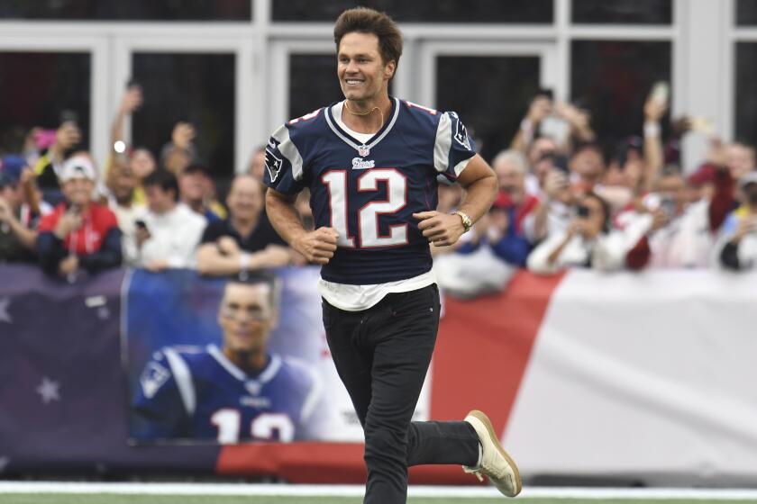 Former New England Patriots quarterback Tom Brady runs on the field during halftime ceremonies held to honor him at an NFL football game between the Philadelphia Eagles and the Patriots, Sunday, Sept. 10, 2023, in Foxborough, Mass. (AP Photo/Michael Dwyer)