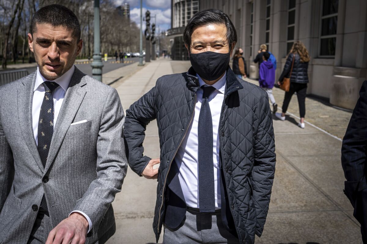 Former Goldman Sachs executive Roger Ng, right, leaves federal court, Friday, April 8, 2022 in New York. A U.S. jury convicted Ng on all counts in $4.5 billion scheme to loot Malaysian fund 1MDB. (AP Photo/Robert Bumsted)