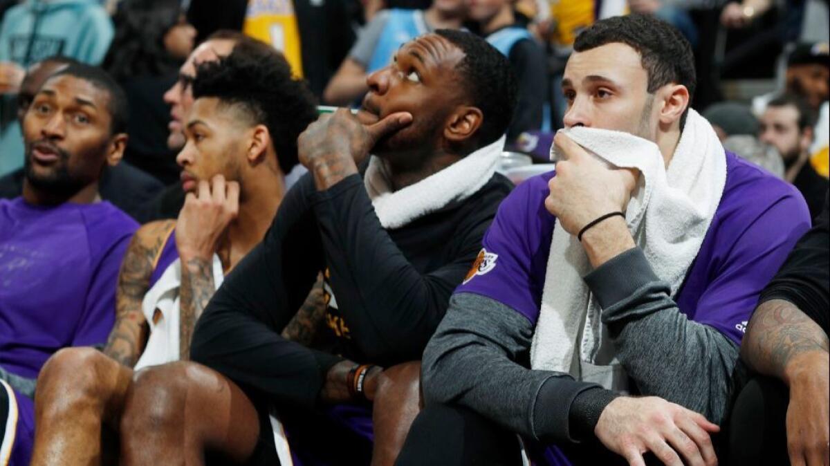 Lakers forward Larry Nance Jr. looks on from the bench with his teammates as time runs out in a game against the Nuggets in Denver on March 13.