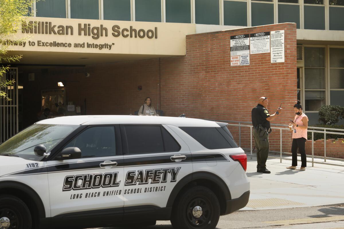 A school safety vehicle is parked in front of Millikan High School in Long Beach.