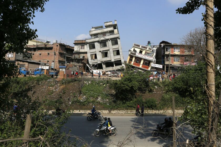 Damaged buildings teeter to their sides in Katmandu, Nepal, after a 7.8 earthquake.