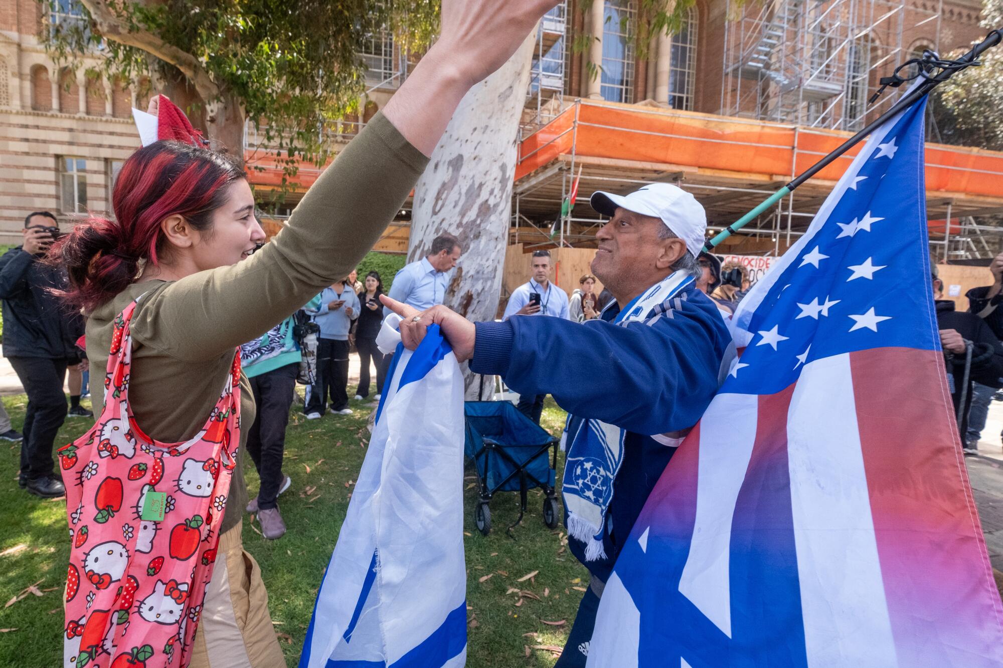 Robert Shaman, right, faces off with with a pro-Palestine protester near an encampment on the campus of UCLA.