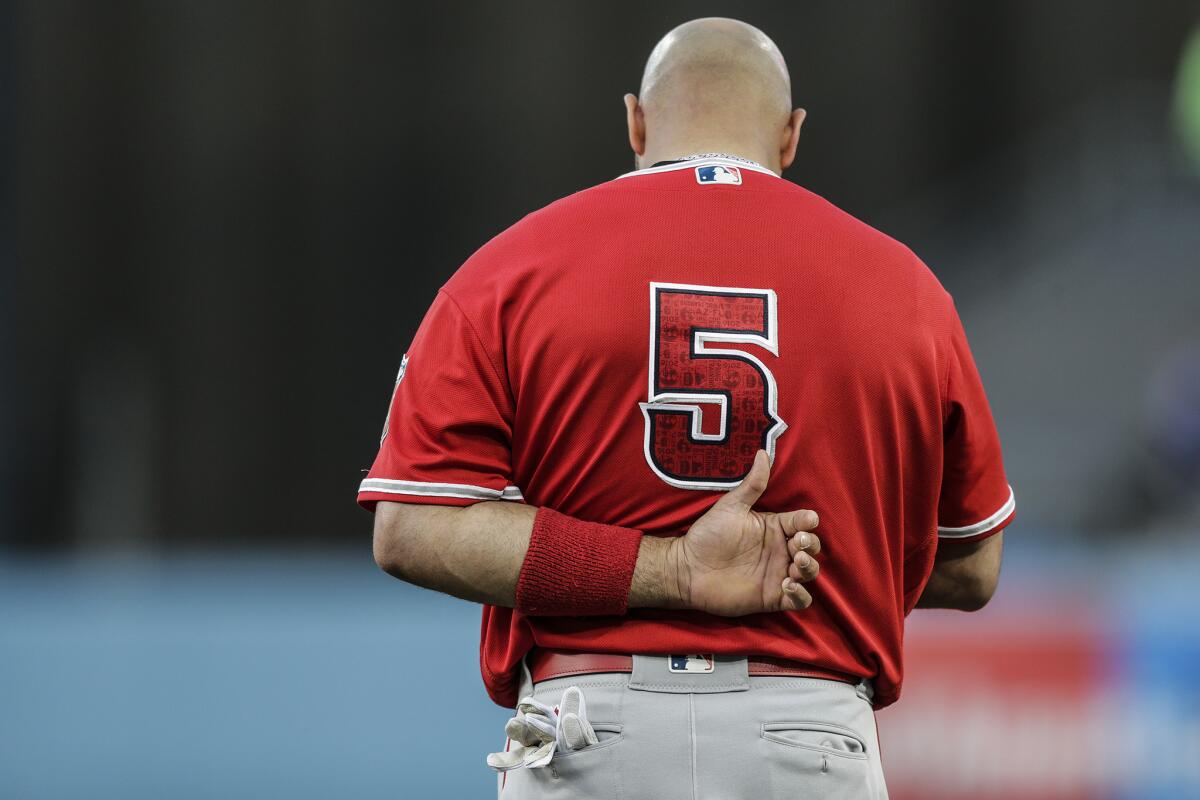Angels slugger Albert Pujols stands for the national anthem before a game against the Dodgers on March 31.