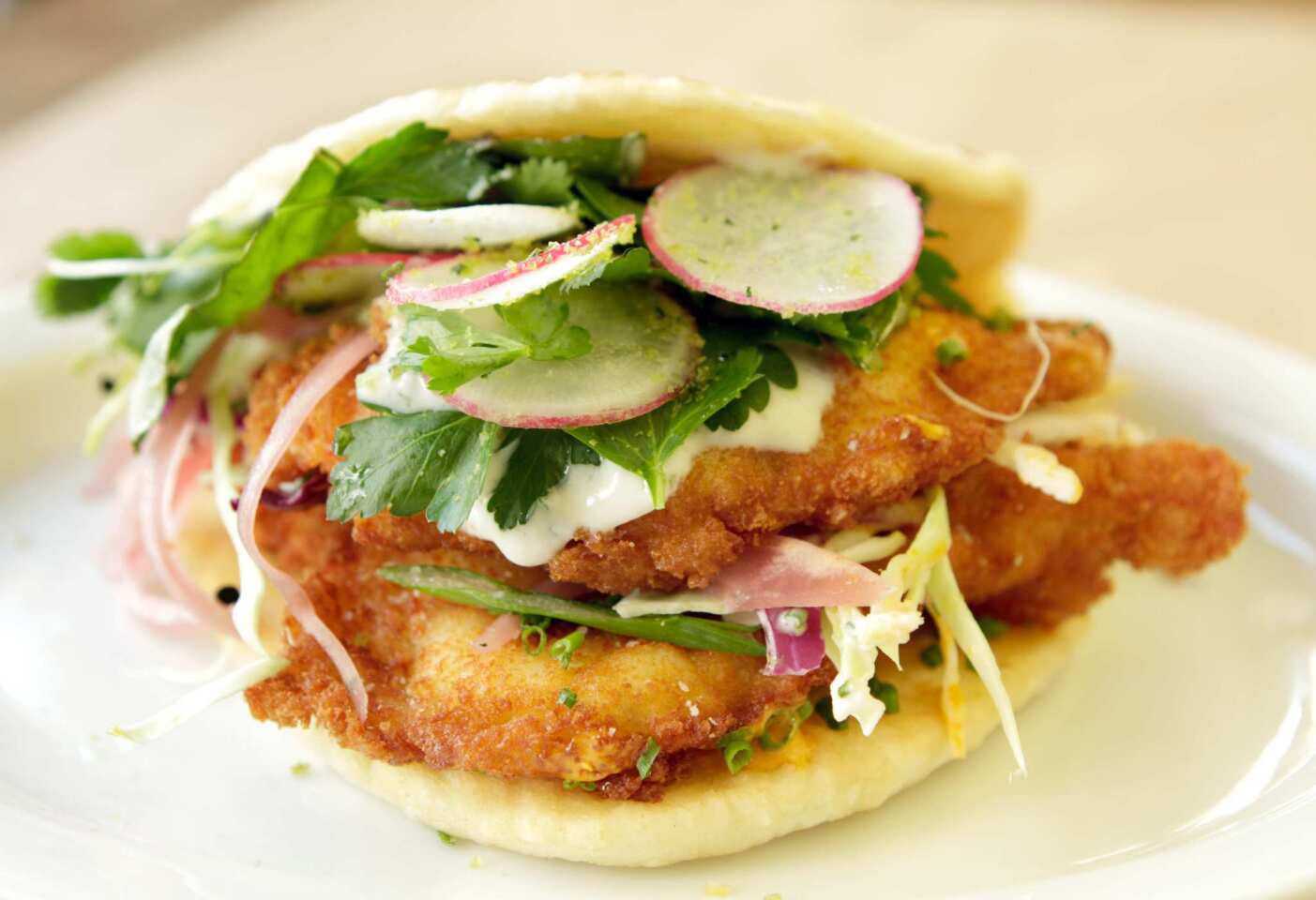 "El Pesco" baco (a flatbread sandwich) with crispy shrimp, house-made sriracha and chive dressing.