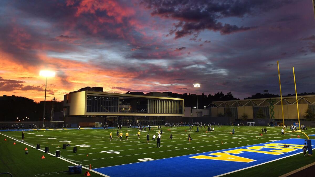 Bruins football players open training camp at the new Spaulding Field on the UCLA campus.