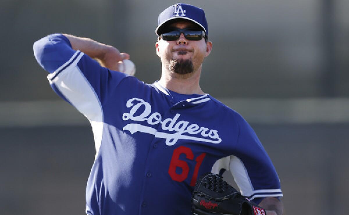 Dodgers pitcher Josh Beckett throws during a spring-training practice session in Glendale, Ariz., on Feb. 10. An ankle injury could derail Beckett's scheduled start Wednesday against the Detroit Tigers.