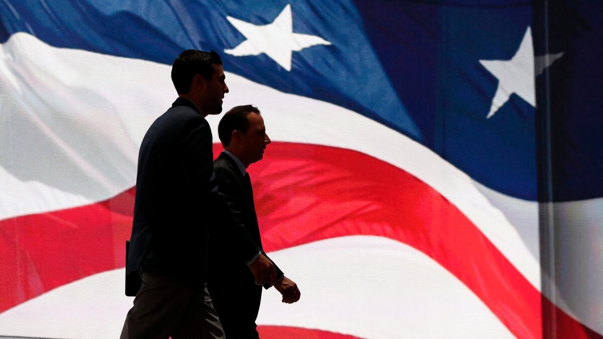 Members of the Republican National Committee check the stage in advance of the GOP convention in Cleveland.