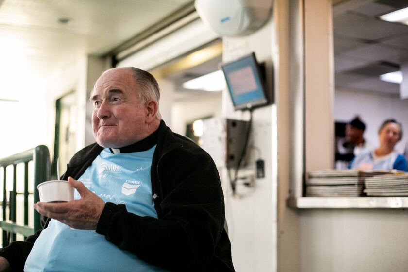 Father Joe Carroll samples some of the food the day before Thanksgiving at Father Joe's Villages in 2019. 