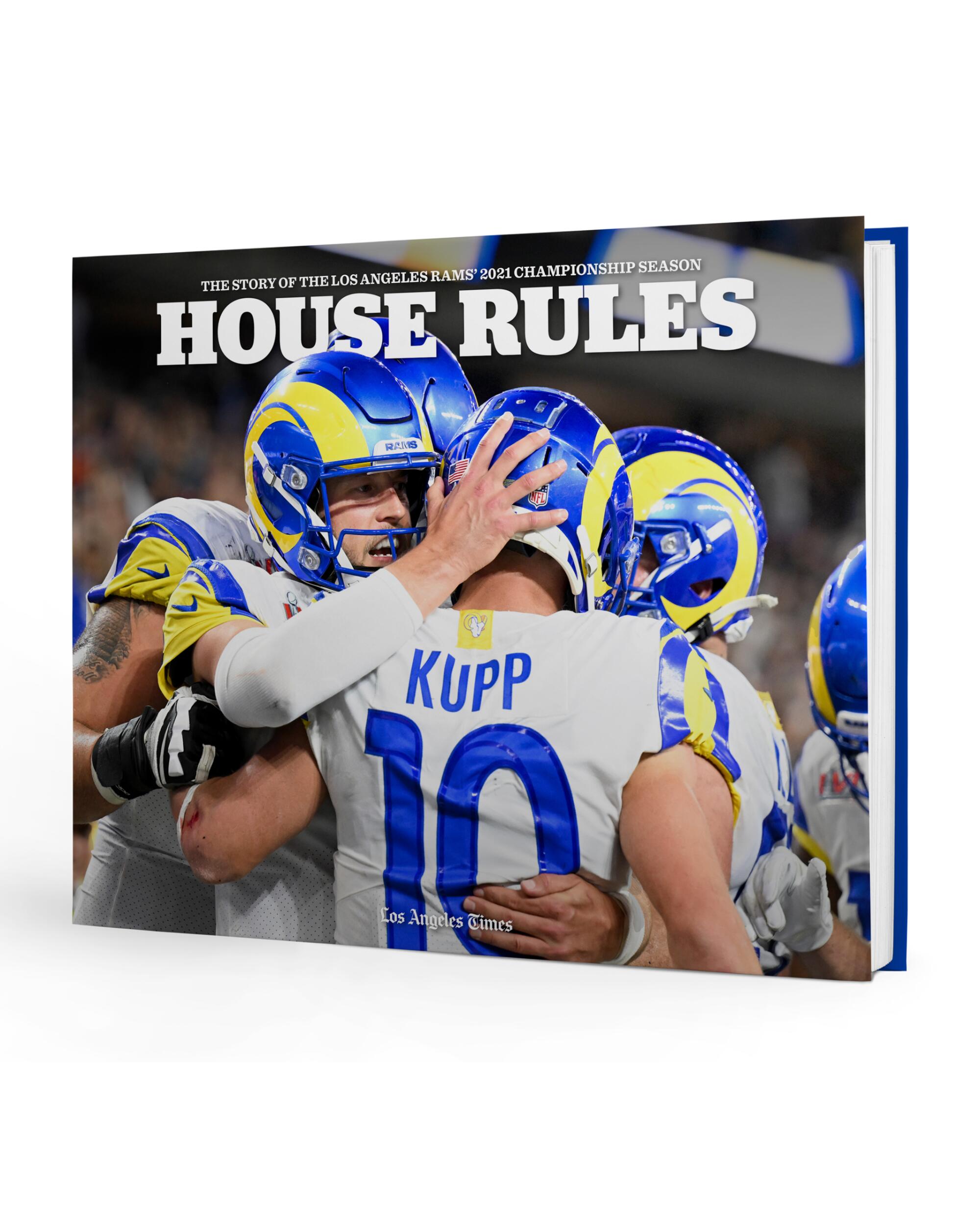 A book with a cover photo of Rams wide receiver Cooper Kupp and his teammates embracing