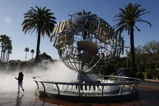 UNIVERSAL CITY, CALIFORNIAB- MARCH 14, 2013: On a beautiful day in Southern California, Pammy Hamm, 6, runs through the spray at the entrance of Universal Studios Hollywood waiting for the park to open in Universal City, California on March 14, 2013. She was visiting along with her family from Dallas. (Gary Friedman)