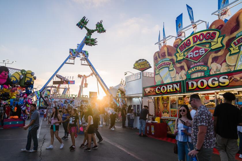 People walk around at the San Diego County Fair at the Del Mar Fairgrounds on July 1, 2022.