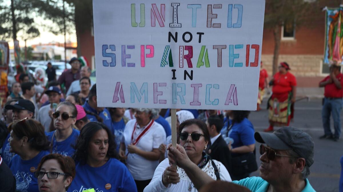 People show solidarity with migrants at an interfaith service at St. Patrick Cathedral in El Paso.