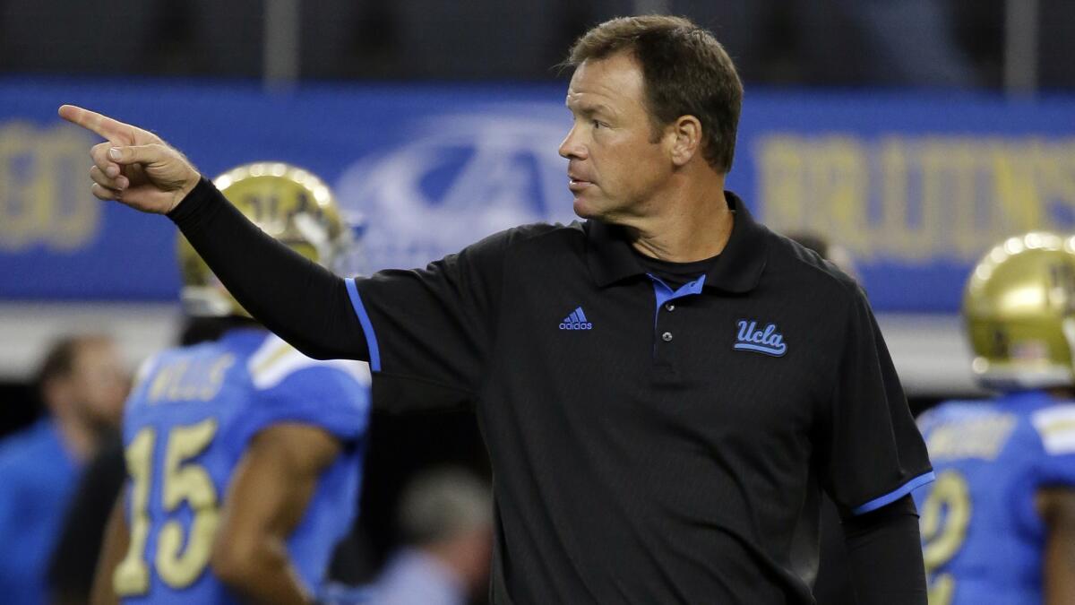 UCLA Coach Jim Mora instructs his players before last week's game against Texas.