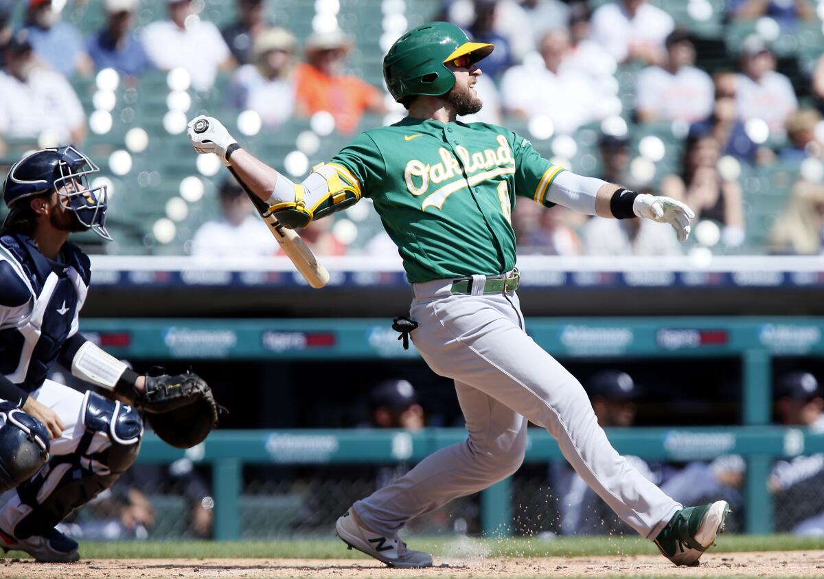 Oakland Athletics' Jed Lowrie (8) watches his three-run home run against the Detroit Tigers during the first inning of a baseball game Thursday, Sept. 2, 2021, in Detroit. (AP Photo/Duane Burleson)