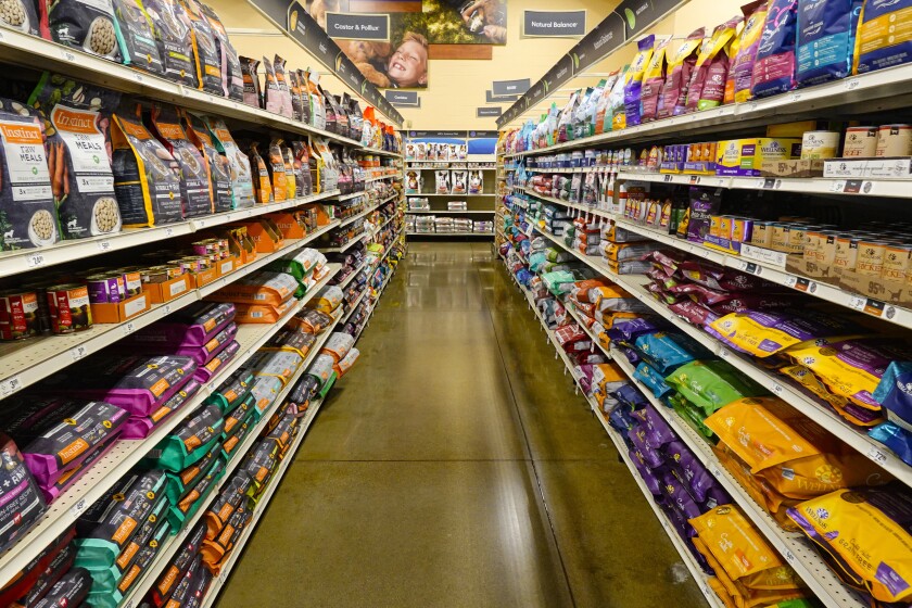 Dog food is shown in a pet store in Westfield, Ind., Tuesday, July 19, 2022. In 2018, the FDA began investigating whether the increasing popularity of grain-free dog foods had led to a sudden rise in a potentially fatal heart disease in dogs. Four years later, the FDA has reached no conclusion, but the publicity surrounding the issue has shrunk the once-promising market for grain-free dog foods. (AP Photo/Michael Conroy)