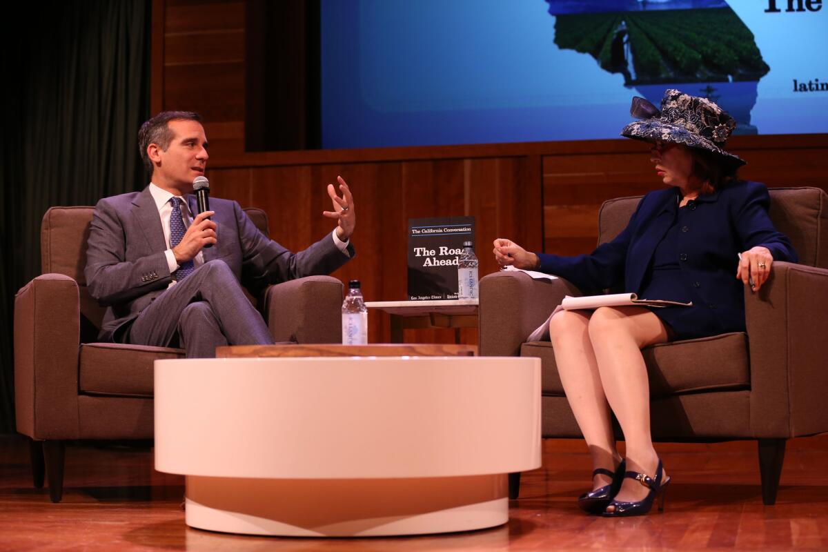 Los Angeles Mayor Eric Garcetti speaks with Patt Morrison during the Los Angeles Times' "The Road Ahead" California Conversation transit panel at the Mark Taper Auditorium on Monday.