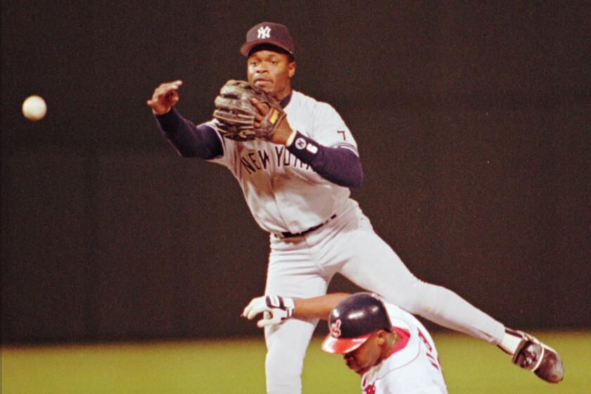 New York Yankees shortstop Tony Fernandez throws over Wayne Kirby of the Cleveland Indians to complete a double play on Indians batter Carlos Baerga in the third inning Tuesday, Sept. 12, 1995, in Cleveland. (AP Photo/Tony Dejak) ORG XMIT: CDB105