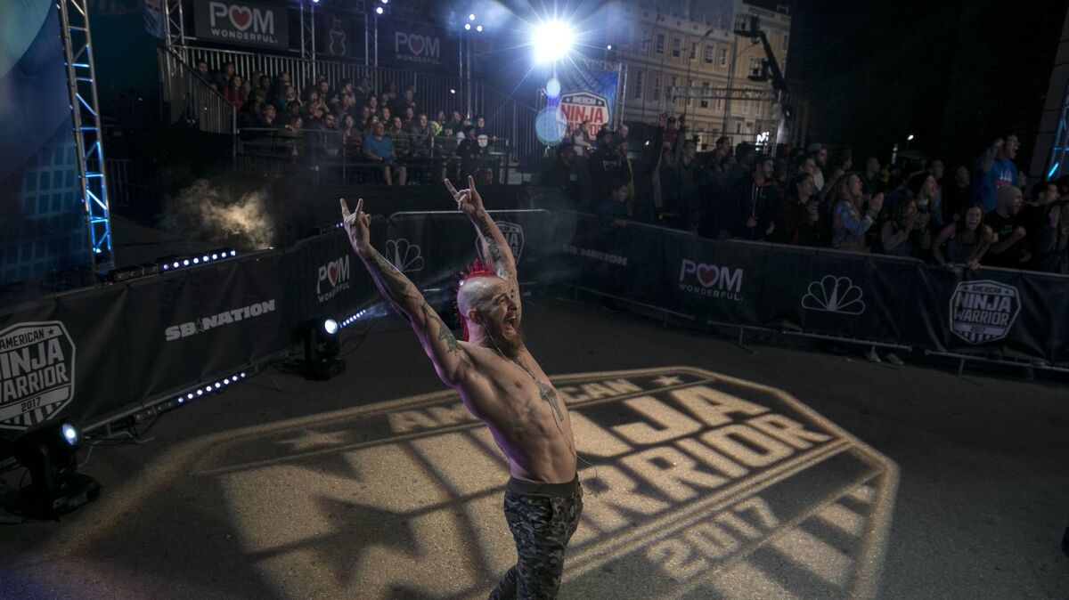Stephen Seiver cheers on a fellow athlete competing in the NBC production of "American Ninja Warrior" at Universal Studios.