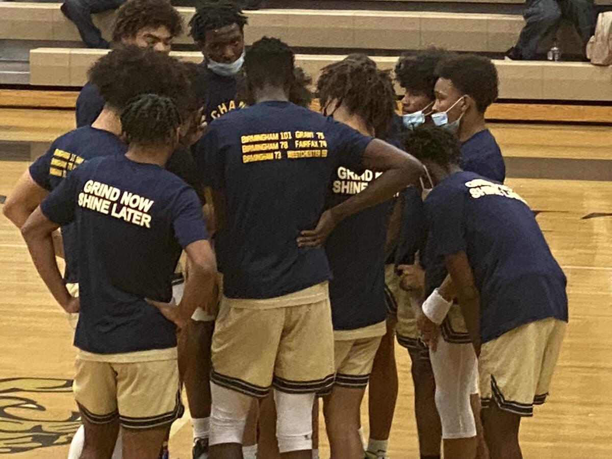 Birmingham players gather to listen to coach Nick Halic.