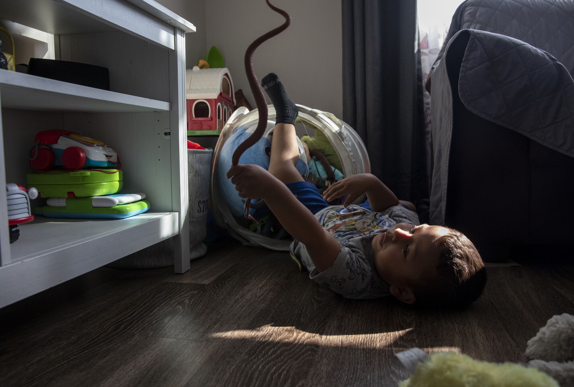 Linda Vista, California - July 13: Mateo, 2, plays on the living room floor of his family's home.