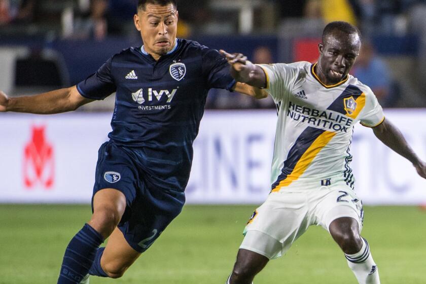 CARSON, CA - JUNE 24: Ema Boateng #24 of Los Angeles Galaxy with the ball as Roger Espinoza #27 of Sporting Kansas City defends during the Los Angeles Galaxy's MLS match against Sporting KC at the StubHub Center on June 24, 2017 in Carson, California. Sporting Kansas City won the match 2-1 (Photo by Shaun Clark/Getty Images) ** OUTS - ELSENT, FPG, CM - OUTS * NM, PH, VA if sourced by CT, LA or MoD **