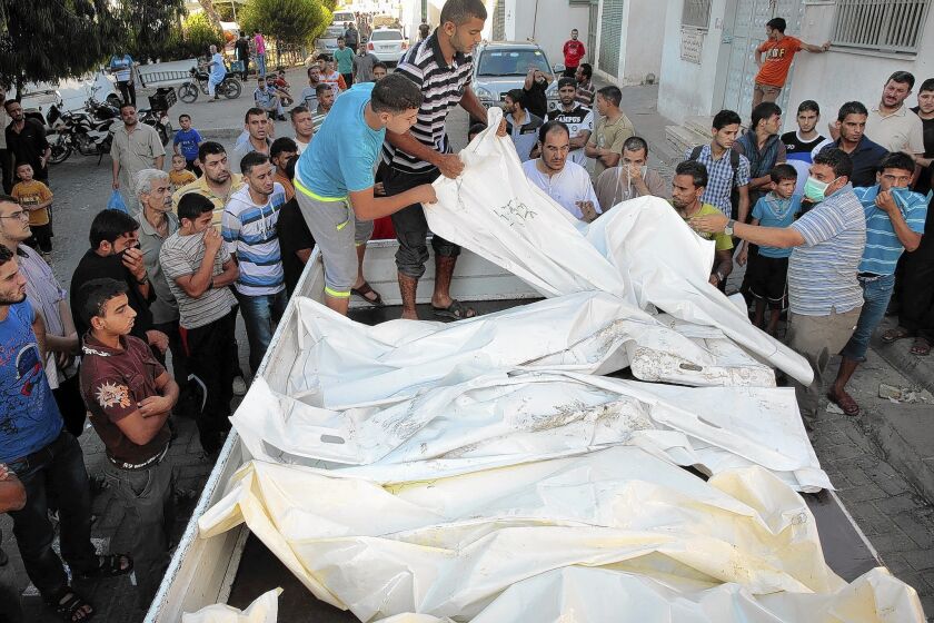 The bodies of 11 members of the Hilo family, who died in the bombing of their Shajaiya home, are taken for burial in Gaza City.