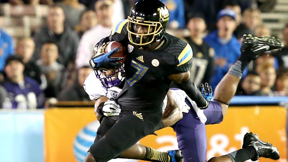 UCLA wide receiver Devin Fuller fight for extra yardage after making a catch against Washington during a game on Nov. 15, 2013.